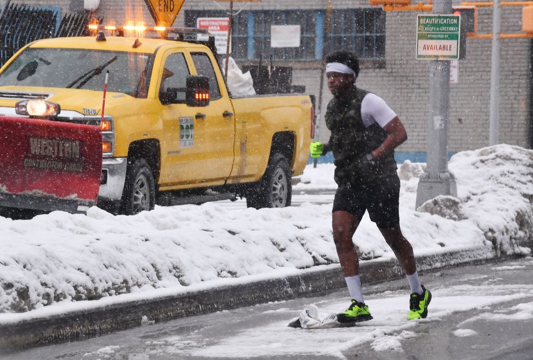 A jogger in Red Hook as snow falls.